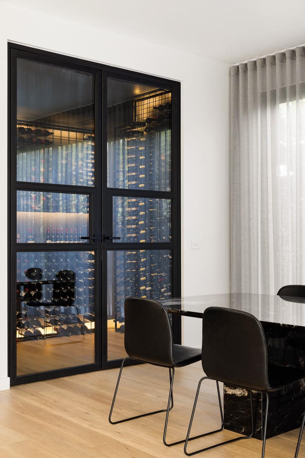 Contemporary, sleek steel doors leading to a wine cellar