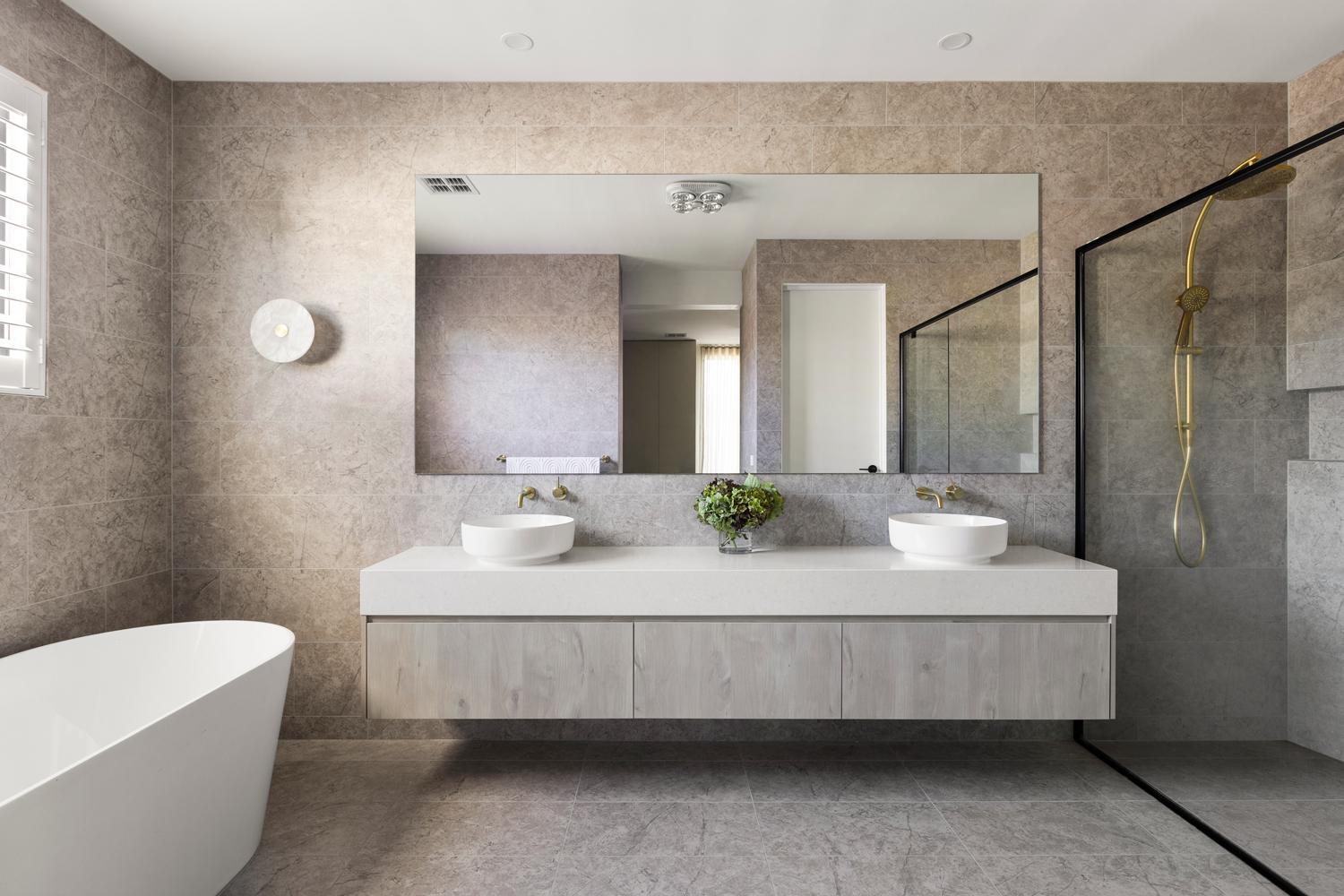 Luxurious ensuite with floor to ceiling stone tiles