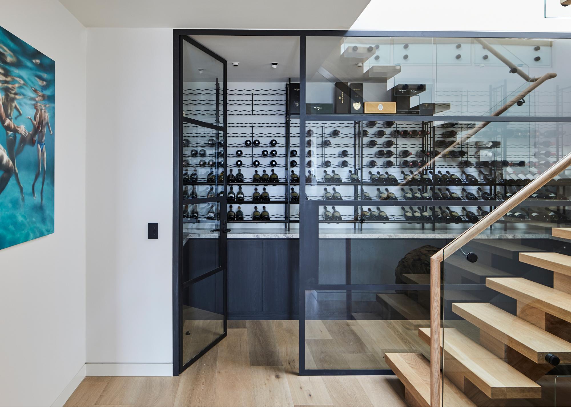 Walk In Wine Cellar With Glass Door And Wall