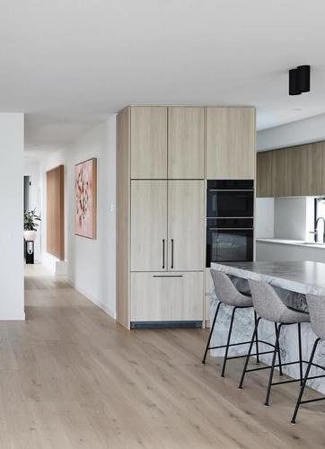 Light Timber Cabinetry And Stone In Kitchen And Dining Space