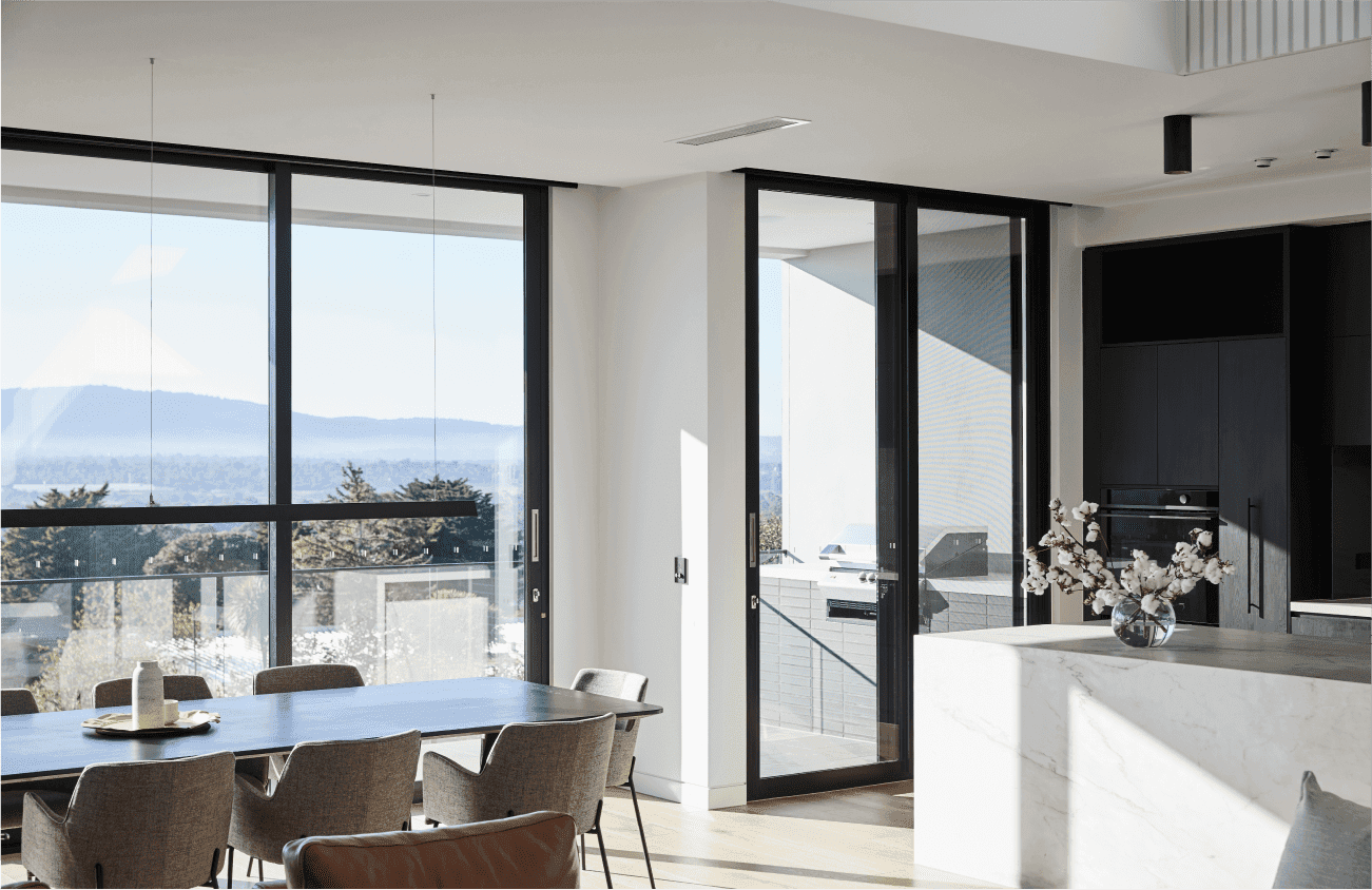 Large floor to ceiling windows in modern dining and kitchen space