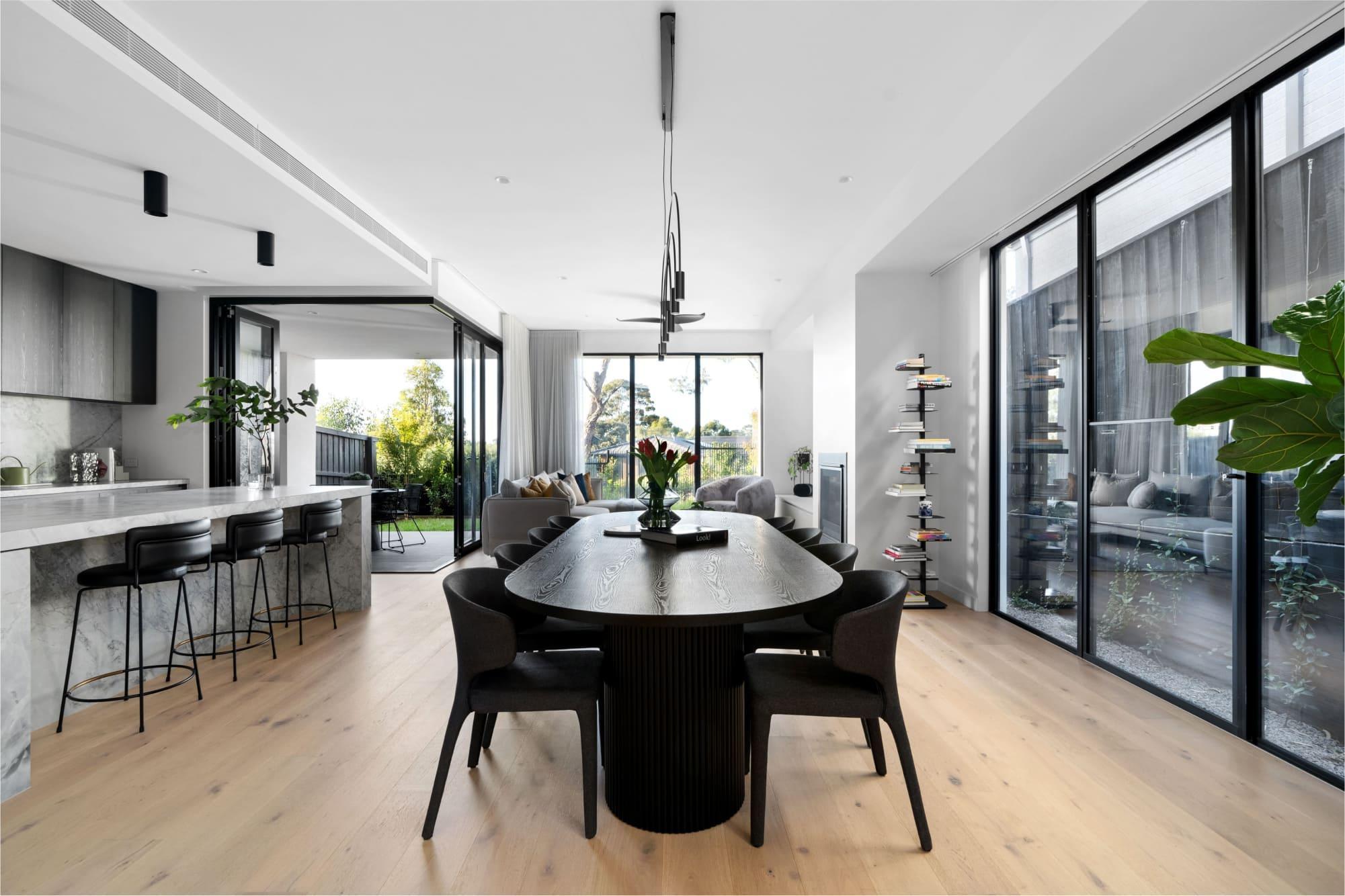 A modern open plan kitchen and dining with expansive windows