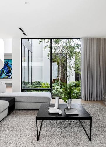 A contemporary living room featuring a spiral staircase.