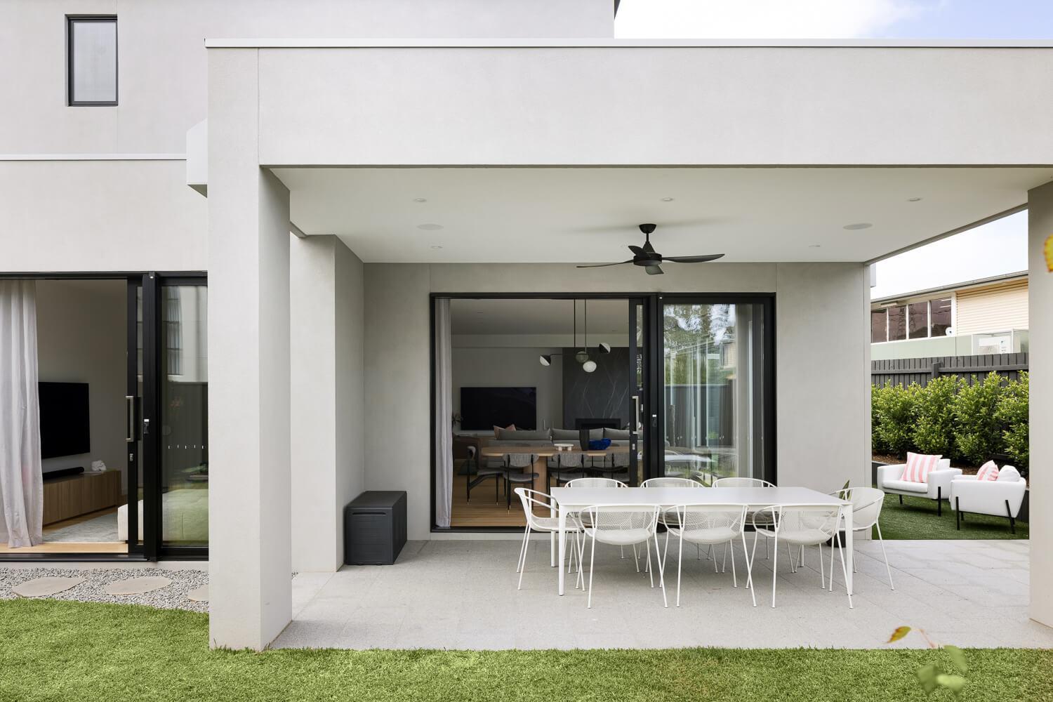 External dining space with large sliding doors connecting to the house