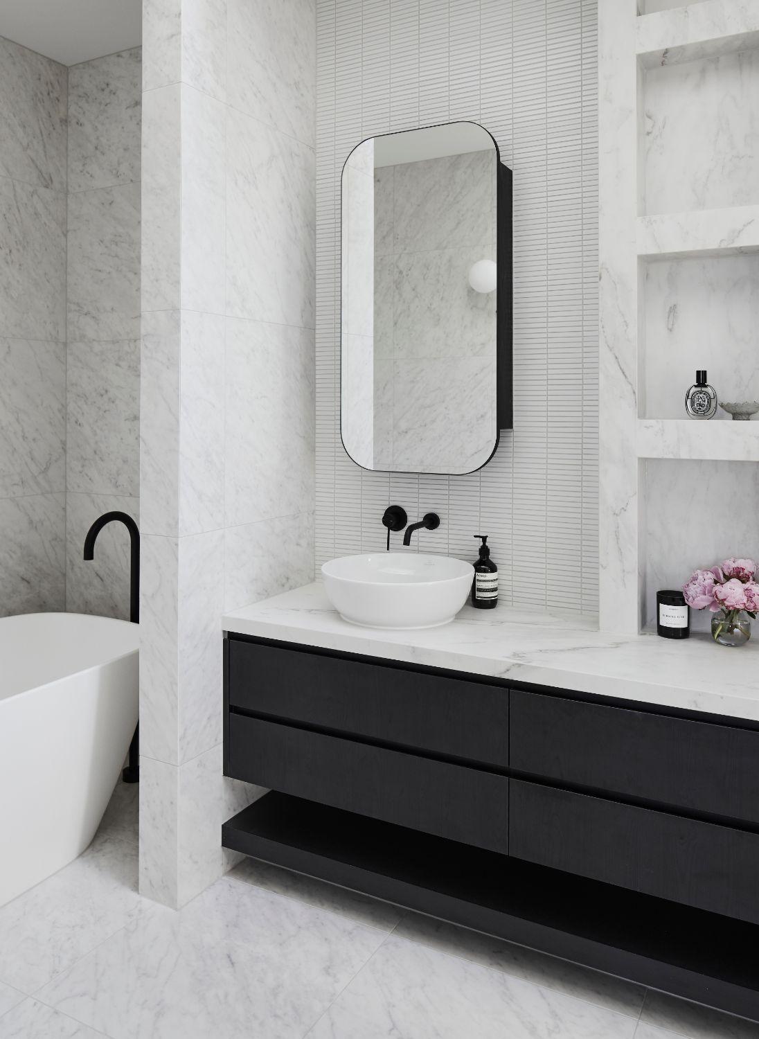 White Stone Used Floor To Ceiling In Ensuite With Black Drawers And Fittings