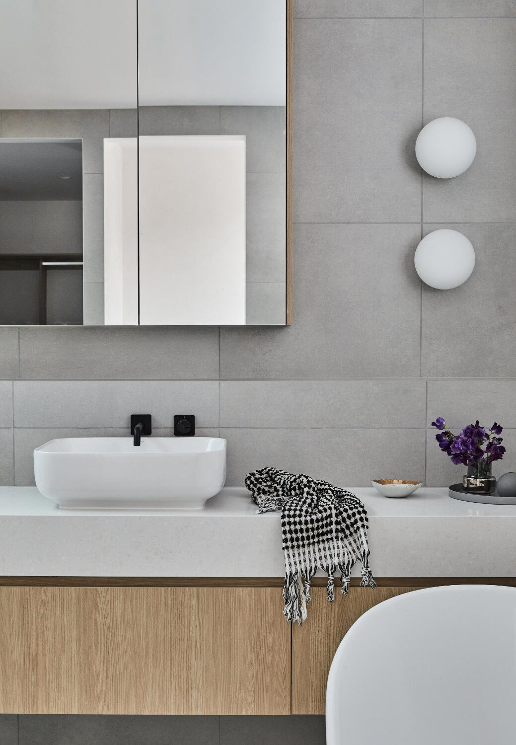 Contrasting White Benchtop And Tiling And Timber Cabinetry In Ensuite