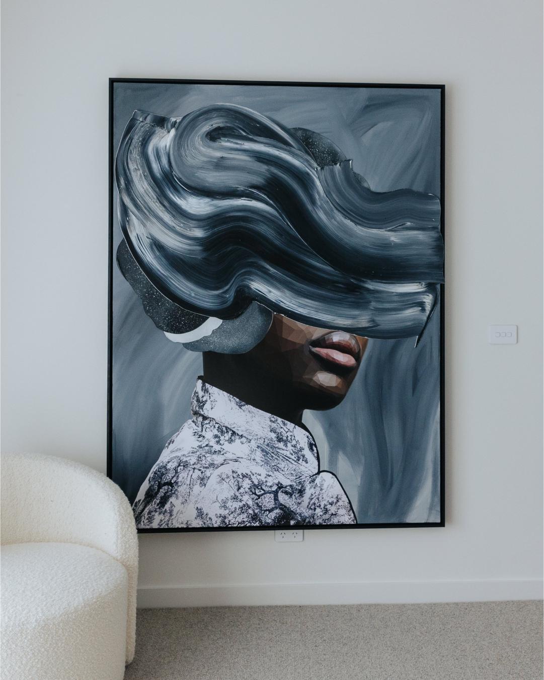 An art piece showcasing a woman' evokes a sense of mystery…A cool, edgy piece that sits beautifully in the master bedroom of The Elba.