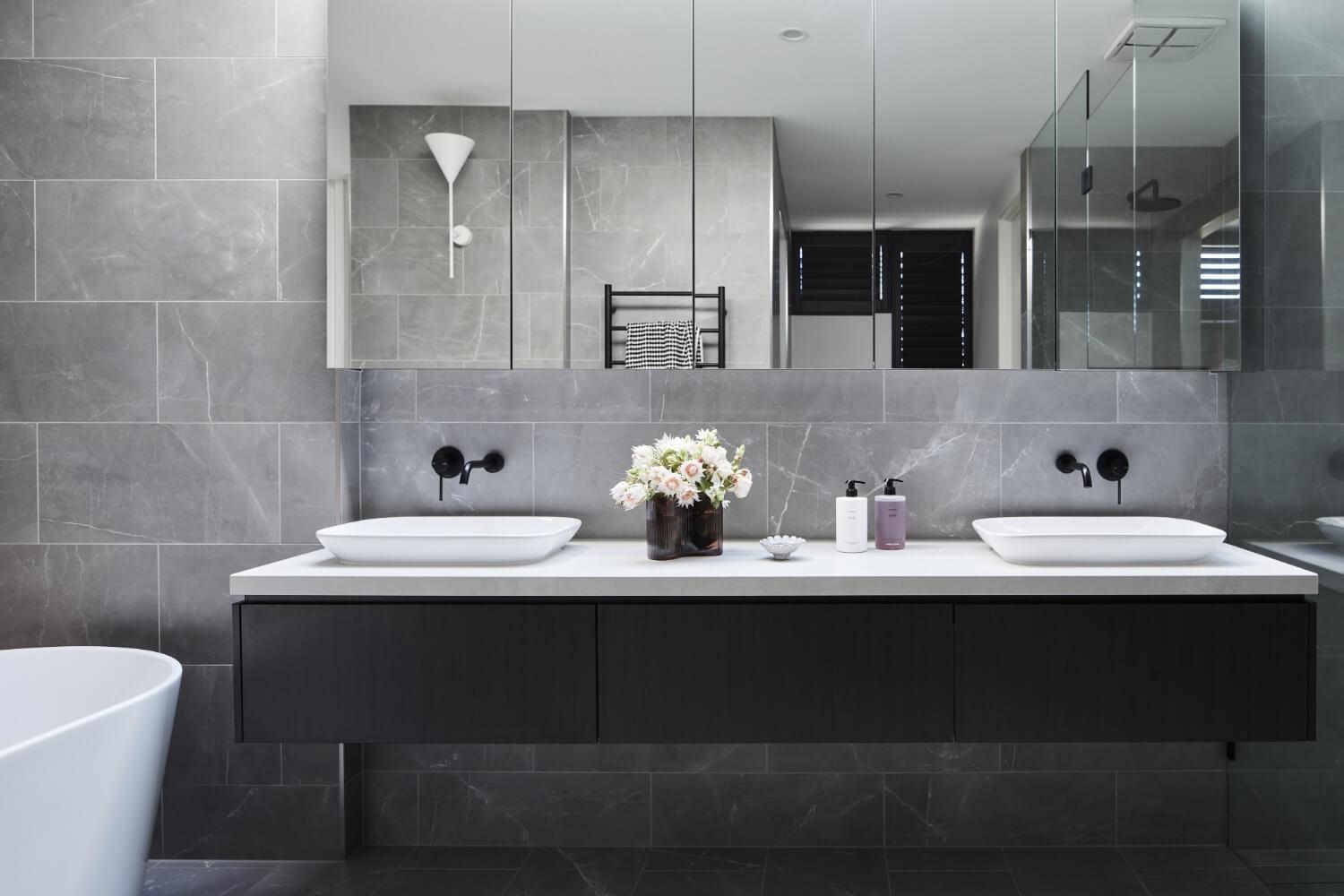 Dark Tone Vanity And Tiling Pairing With Contrasting Sinks And Bathtub