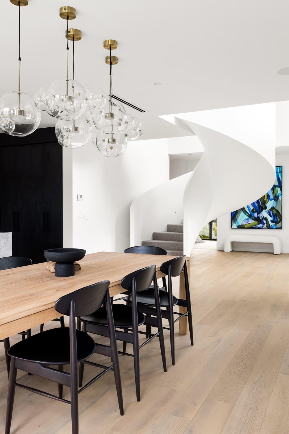 A contemporary dining room featuring a spiral staircase.