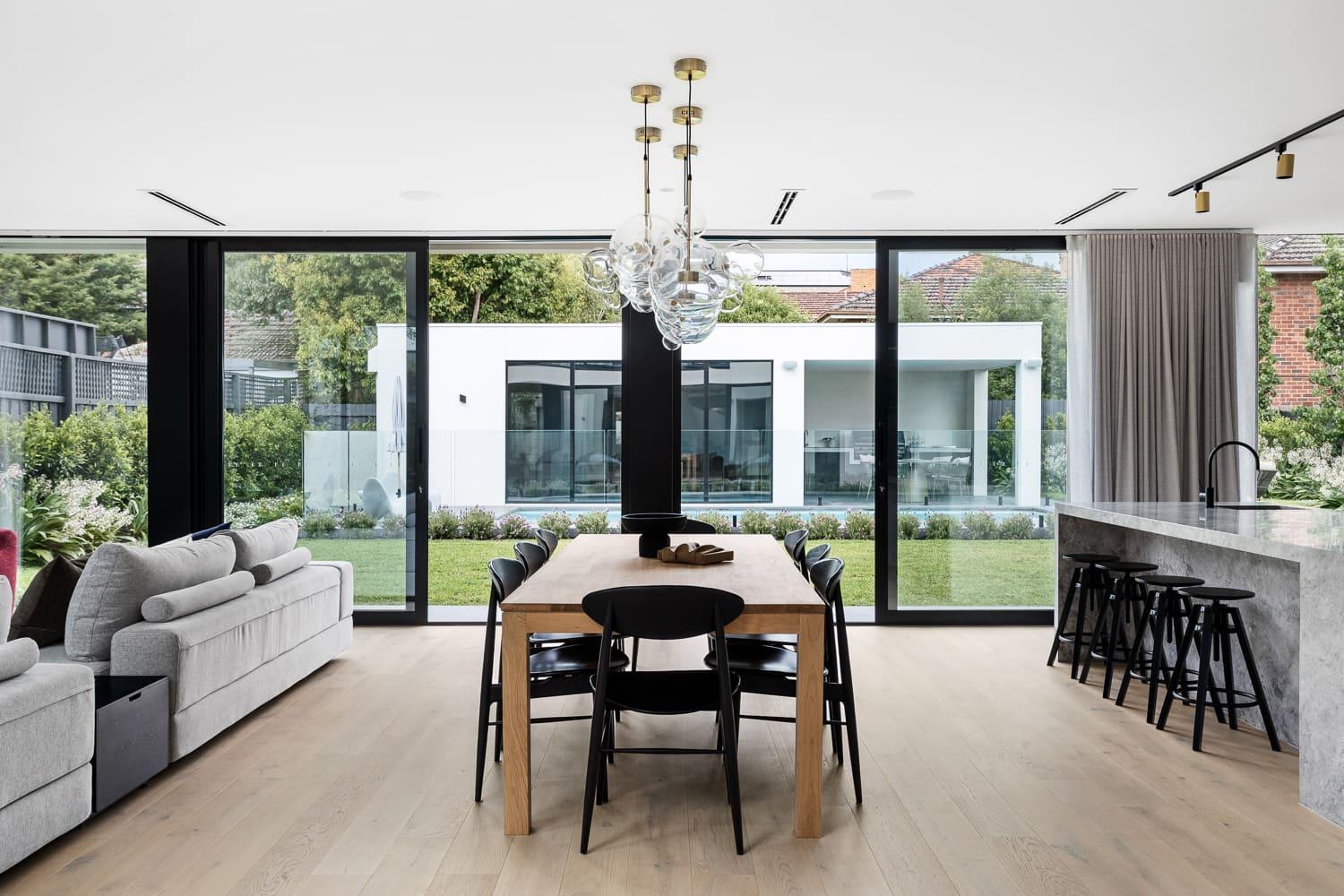 A sleek, contemporary kitchen and dining area in a modern home