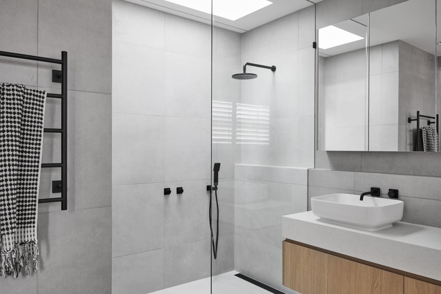 Frameless Shower With Black Fittings And Grey Floor To Ceiling Tiling