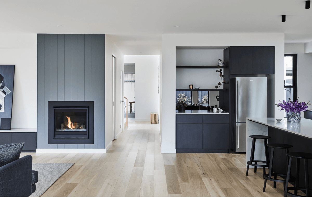 Modern kitchen with fireplace, hallway and living space