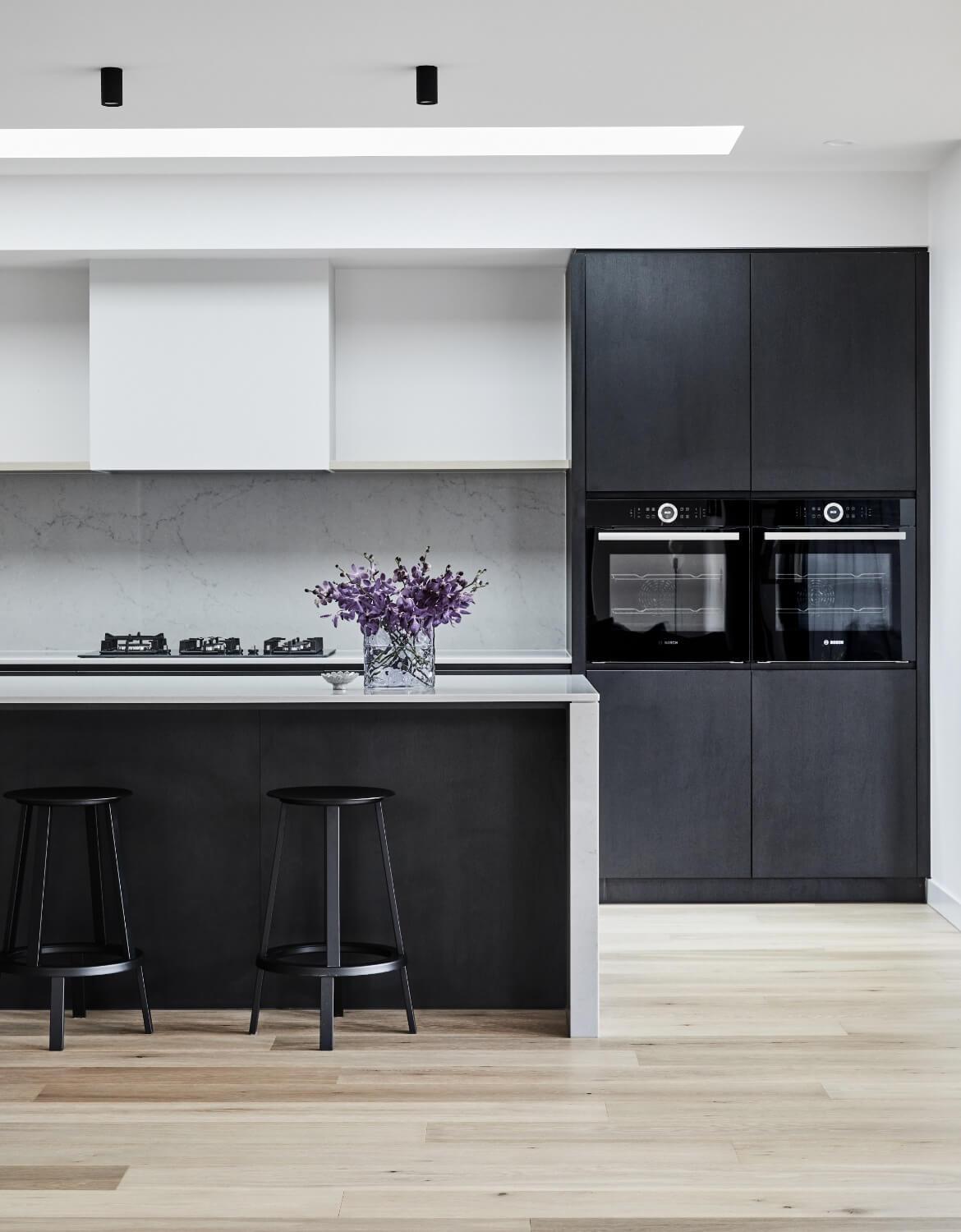 Black Integrated Appliances And Stools Compliment Kitchen Palette